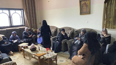 Mirvat, Mohammed Al-Na'em's mother surrounded by women at son's funeral