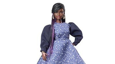 Dr Aderin-Pocock doll is wearing a starry blue dress and chunky earrings.