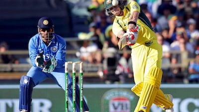Australia's Steve Smith, right, hits a six as India's wicketkeeper MS Dhoni looks on during the Day 1 of their ODI series in Perth January 12, 2016. REUTERS/Bill Hatto