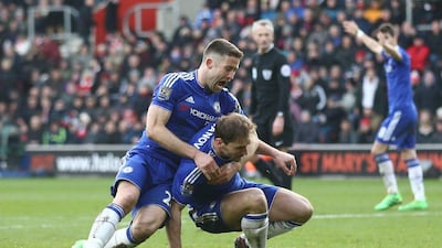 Chelsea's English defender Gary Cahill (L) celebrates with Chelsea's Serbian defender Branislav Ivanovic (R) after Ivanovic scored their second goal during the English Premier League football match between Southampton and Chelsea at St Mary's Stadium in Southampton, southern England on February 27, 2016. RESTRICTED TO EDITORIAL USE. No use with unauthorized audio, video, data, fixture lists, club/league logos or 'live' services. Online in-match use limited to 75 images, no video emulation. No use in betting, games or single club/league/player publications. / AFP / JUSTIN TALLIS / RESTRICTED TO EDITORIAL USE. No use with unauthorized audio, video, data, fixture lists, club/league logos or 'live' services. Online in-match use limited to 75 images, no video emulation. No use in betting, games or single club/league/player publications.
