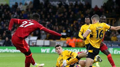 Liverpool's Divock Origi scores against Wolves. PA