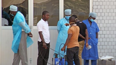 Medical personnel at the emergency entrance of a hospital wait to receive suspected Ebola virus patients in Conakry, Guinea on March 29. Youssouf Bah / AP