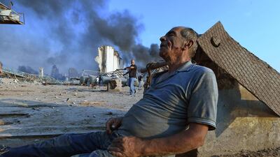 A wounded man waits for aid at Beirut's port following the massive explosion that hit the heart of the Lebanese capital on August 4, 2020. AFP