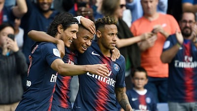 Paris Saint-Germain's Kylian Mbappe, centre, is congratulated by Neymar, right, and Edinson Cavani after scoring a goal. AFP