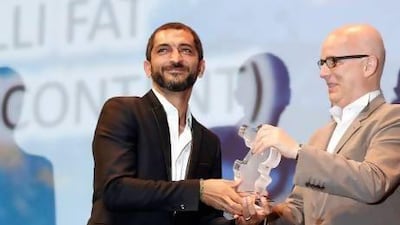 The Eygptian actor Amr Waked, left, accepts an award at the Dubai International Film Festival in December. Karim Sahib / AFP