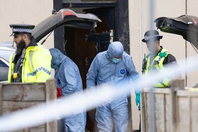 Police forensic officers search a house in Rochdale on Sunday. Getty
