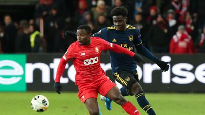 Arsenal's Bukayo Saka, right, vies for the ball with Liege's Collins Fai during the Europa League match at the Maurice Dufrasne stadium. AP