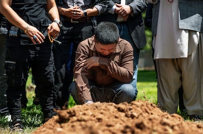 Altaf Hussain cries over the grave of his brother Aftab Hussein at Fairview Memorial Park in Albuquerque, New Mexico. The Albuquerque Journal / AP