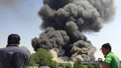 Firefighters struggle to put out a fire that broke out in a textile warehouse in Al Quoz. Razan Alzayani / The National