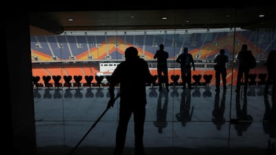A worker cleans an entrance area inside Sardar Patel Stadium in Ahmedabad. Reuters