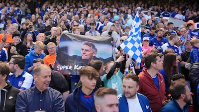 Ipswich Town fans with a banner featuring manager Keiran McKenna. PA