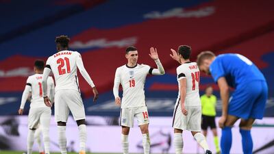 England's Phil Foden, centre, celebrates after scoring his team's fourth goal. AP