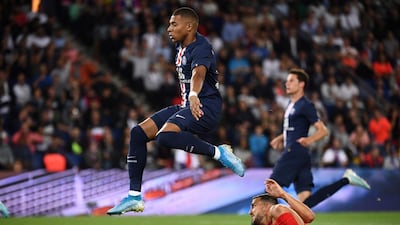 Paris Saint-Germain's French forward Kylian Mbappe (top) avoids Nimes' French defender Pablo Martinez. AFP