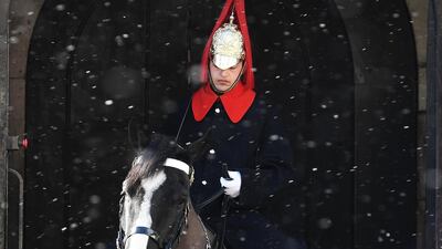 A member of the Household Cavalry on his horse on guard duty at Horseguards Parade as the snow falls in central London. Andy Rain / EPA