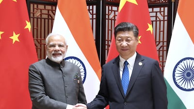Narendra Modi and Xi Jinping shake hands as they pose for a photo during a meeting on the sidelines of the BRICS Summit in Xiamen. AP
