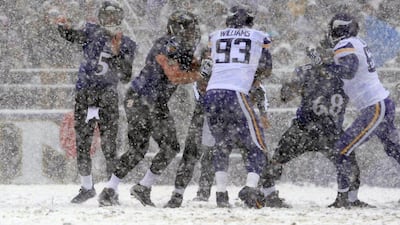 Not far from Washington, in Baltimore, Maryland, the Baltimore Ravens and Minnesota Vikings played in the snow. Above, Baltimore quarterback Joe Flacco, far left, attempts a pass. Gail Burton / AP