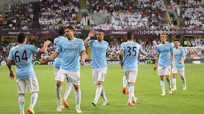 Marcos Lopes of Manchester City celebrates with teammates after scoring the first goal. Francois Nel / Getty Images