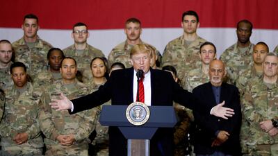 President Donald Trump delivers remarks to US troops with Afghanistan President Ashraf Ghani standing behind him during an unannounced visit to Bagram Air Base in Afghanistan. Reuters, file