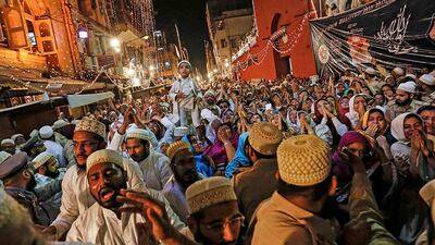 Dawoodi Bohra Muslims raise their arms as they take blessings from their new spiritual leader Syedna Mufaddal Saifuddin in Mumbai. Danish Siddiqui / Reuters