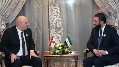 Lebanese President Joseph Aoun, left, meets Syria's interim President Ahmad Al Shara at the emergency Arab summit at Egypt's New Administrative Capital, just outside Cairo. AP