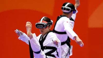 Nakajima Miho, left, loses to Suzuki Hayate in the virtual taekwondo contest during the 2026 Asian Games in Toyohashi, Japan. AFP