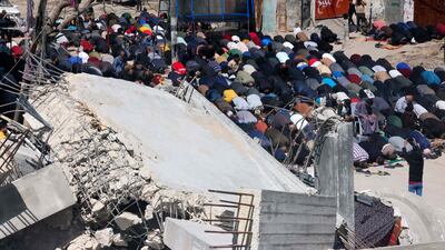 Palestinians perform the first Friday noon prayer of Ramadan in front of the ruins of Al Farouq Mosque in Rafah, which was destroyed in Israeli bombardment. AFP