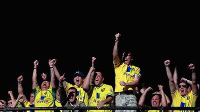 Norwich fans celebrate the third goal in their 3-1 win against fellow promoted club Swansea City at Carrow Road. Jamie McDonald / Getty Images