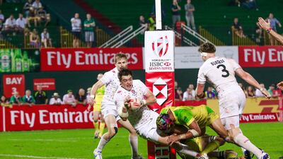 England, in white, played Australia in a match on Day 2 of the Dubai Rugby Sevens. Victor Besa for The National