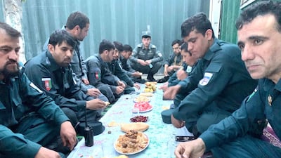 Afghan policemen gather for their iftar in a bunkered enclosure at a check-post in central Kabul. They take turns to break their fast while their colleagues stand guard outside. Hikmat Noori for The National