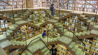 People climb the stairs at a book shop in Hangzhou, in eastern China's Zhejiang province. AFP