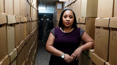 Fulton County District Attorney Fani Willis poses among boxes containing thousands of primal cases at her office in Atlanta, Georgia. AP