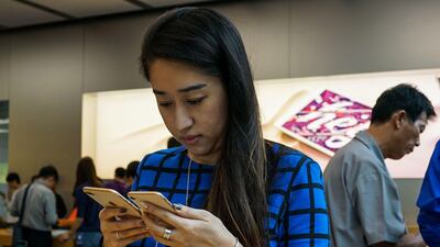 A Chinese girl look at the Apple iPhone 8 and 8 Plus in Shanghai. Chandan Khanna / AFP Photo