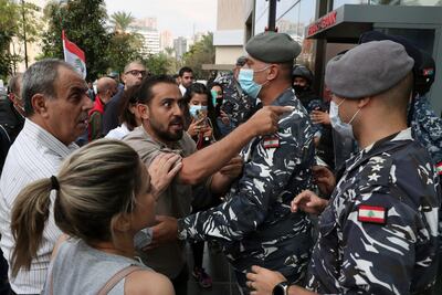 Bank customers scuffle with riot police as they try to storm a bank in Beirut in November 2021. AP