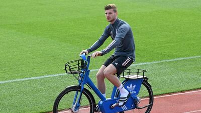 Germany forward Timo Werner arrives on a bicycle. AFP