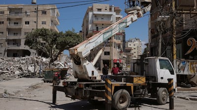 Workers repair electricity infrastructure, damaged during Israeli strikes on Wednesday, in Tyre, south Lebanon. Reuters