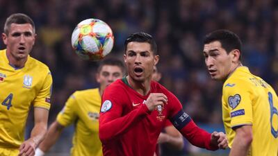 Ukraine`s Taras Stepanenko in action against Portugal`s Cristiano Ronaldo. EPA