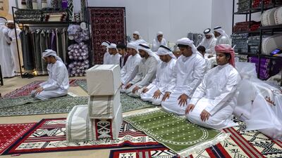 Prayer time at the exhibition. Victor Besa / The National
