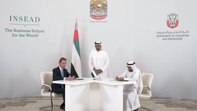 Sheikh Mohammed bin Zayed, Crown Prince of Abu Dhabi and Deputy Supreme Commander of the UAE Armed Forces, centre, witnesses an MOU signing, during a Sea Palace barza. Seen signing on behalf of the department of Education and Knowledge is Dr Ali Rashid Al Nuaimi, Director General of Abu Dhabi Education Council and Abu Dhabi Executive Council Member, right, and on behalf of INSEAD, Dr Andreas Jacobs, chairman of INSEAD, left. Hamad Al Kaabi / Crown Prince Court - Abu Dhabi