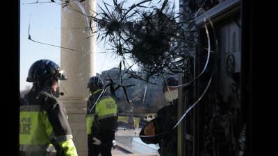 Members of US Capitol Police inspect a damaged entrance of the Capitol in Washington, DC, on Thursday. Getty