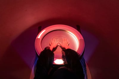 In the ultrasonic therapy room, visitors sit on a stool and place their hands over a humming copper plate. Antonie Robertson / The National