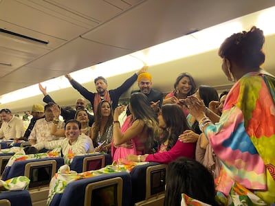 Guests entertain themselves aboard the ceremonial flight. The National