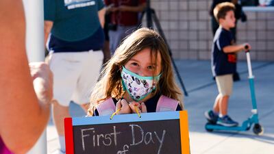 Charlie Gonzalez holds up a sign during the first day of school at the new Hannah Marie Brown Elementary School in Henderson, Nevada, US, on August 9, 2021. AP