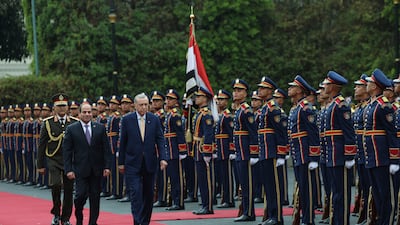 Mr Erdogan, right, reviewed a guard of honour with Mr El Sisi before their talks at Al Ittihadiya Palace in Cairo. AP