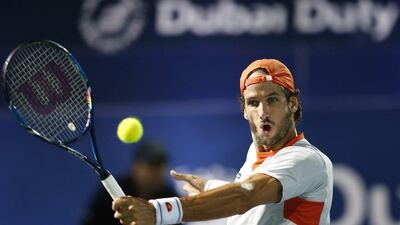 epa05182221 Feliciano Lopez of Spain returns the ball to Marcos Baghdatis of Cyprus during their semi final match of Dubai Duty Free Tennis ATP Championships in Dubai, United Arab Emirates, 26 February 2016. EPA/ALI HAIDER