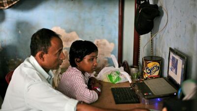 Senwara Begum, right, is helped by her foster father, hamsul bin Sayed,to use Skype to talk to her family members in Myanmar from their temporary shelter in Medan, North Sumatra, Indonesia. "I'm fine," Senwara says, trying to sound upbeat. "I'm with a family that is taking good care of me. They love me. I'm learning things, English and religion." Her father reminds her to be a good girl. He is desperate to see his children again, but believes they are better off far away. AP Photo/Binsar Bakkara