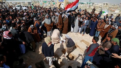 Iraqi men bury the victims of a suspected ISIS attack in the cemetery in Najaf. Reuters