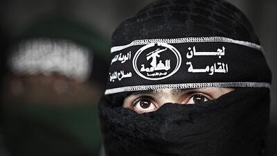 A masked Palestinian militant of the Al Nasser Salah Al Dine Brigades, an armed wing of the Popular Resistance Committees, speaks to the media during a news conference in Gaza City. Ali Ali / EPA