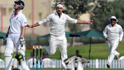 The ICC Combined XI's Hamid Hassan celebrates the wicket of England's Jonathan Trott.