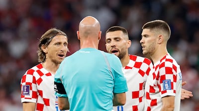 From left, Croatian players Luka Modric, Mateo Kovacic, and Andrej Kramaric argue with referee Anthony Taylor. EPA