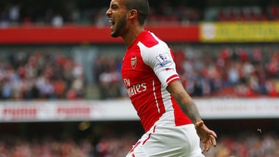 Theo Walcott celebrates after scoring one of his three goals on Sunday in Arsenal's Premier League win over West Brom. Eddie Keogh / Reuters / May 24, 2015
